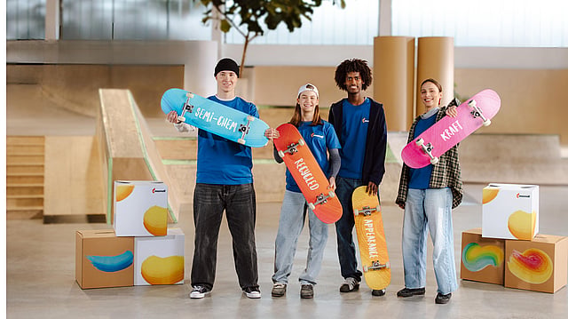 Four young people are holding colourful skateboards, each adorned with the names of Containerboard's various product categories. They are surrounded by Mondi boxes, and in the top left corner, the phrase 